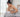ผู้หญิงกุมท้องปวดท้องบิดนั่งบนเตียง / woman with abdominal cramps holding her stomach