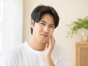 Does Ya Khiao relieve heat — young man touching his cheek from internal heat symptoms
