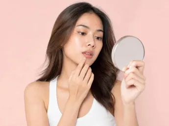 Woman touching blisters on lips, checking for herpes, canker sores or angular cheilitis