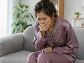 Medicine for nausea — woman covering her mouth feeling nauseous