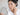 ผู้หญิงส่องกระจกดูฝ้าบนแก้ม / woman looking in a mirror at melasma patches on her cheek