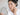ผู้หญิงส่องกระจกดูฝ้าบนแก้ม / woman looking in a mirror at melasma patches on her cheek